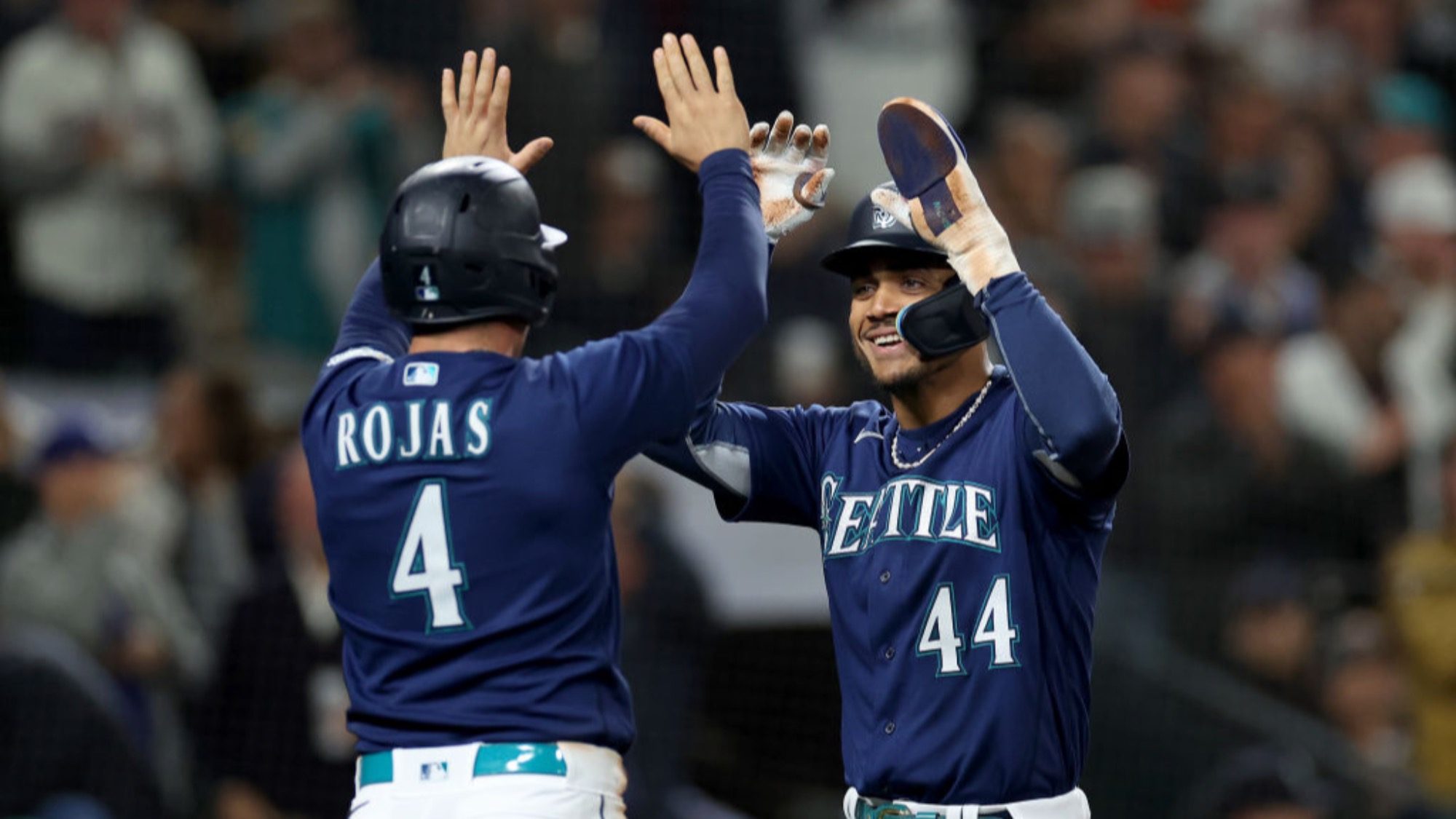 GettyImages-1703384354-16-9-2000x1125 Two of the most popular baseball players in Seattle Mariners uniforms celebrating with a high-five.